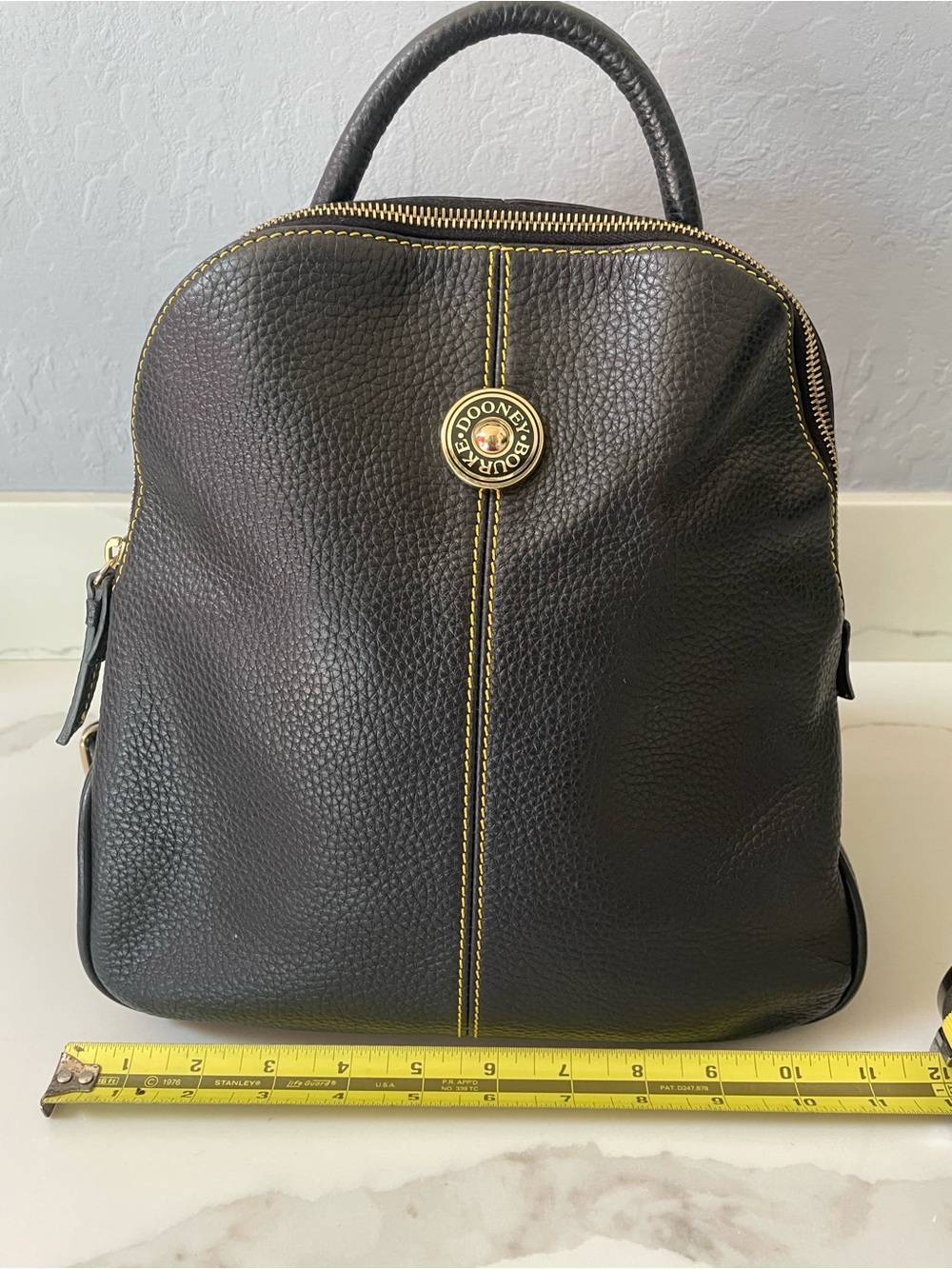 Dooney & Bourke Black Pebbled Leather Backpack with Yellow Stitching
